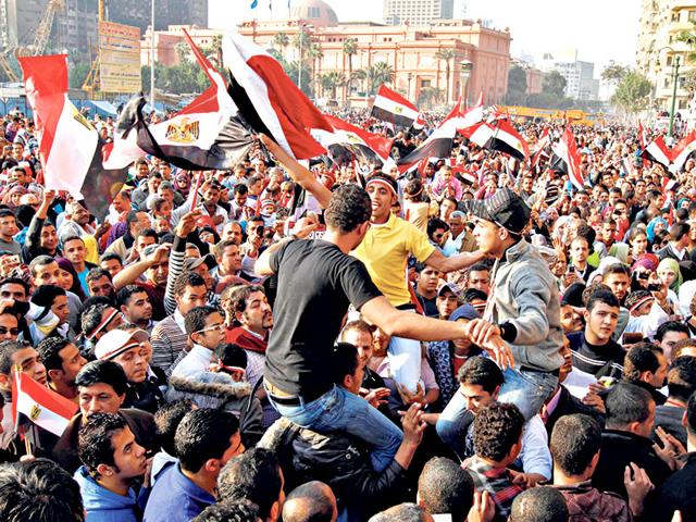 Egyptians-in-Cairo-s-Tahrir-Square-on-February-12-2011-celebrate-the-fall-of-Hosni-Mubarak-MOHAMMED-ABED-AFP-Photo Egyptians-in-Cairo-s-Tahrir-Square-on-February-12-2011-celebrate-the-fall-of-Hosni-Mubarak-MOHAMMED-ABED-AFP-Photo