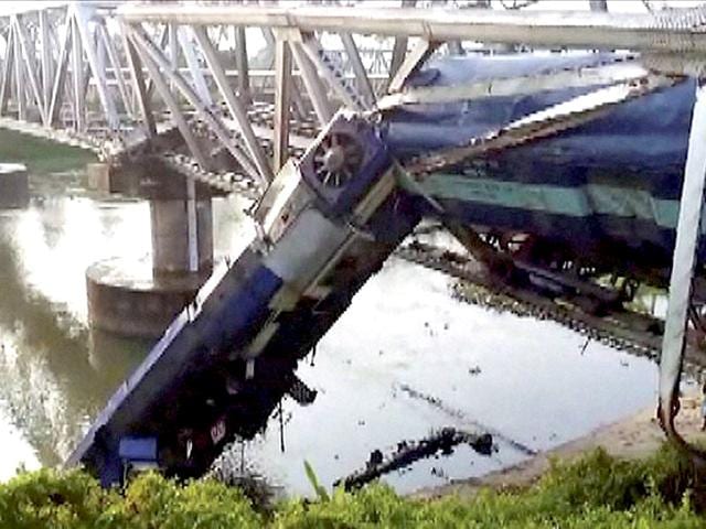 A-passenger-train-hangs-from-a-bridge-after-it-derailed-at-Kokrajhar-district-in-Assam-PTI-Photo