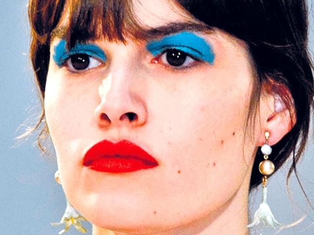 Fashion house Celine broke the beauty rule stylishly by pairing bold eyes with popping lips. Start off by applying primer. Now, generously swipe cerulean blue eyeshadow, so that it almost skims your brows. A swipe of mascara and pop red lips, and you're set to rock.
