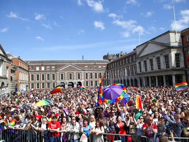 Hundreds of 'Yes' supporters gathered in the grounds of Dublin Castle cheered and waved rainbow flags as the results came through. (AP Photo)
