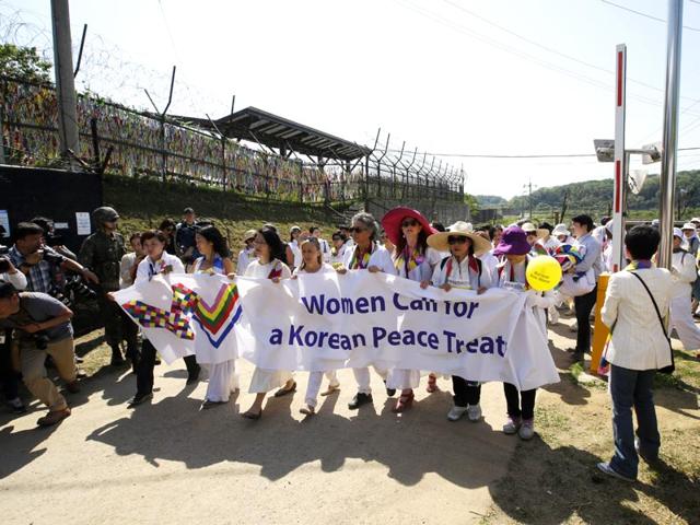 International-activists-march-to-the-Imjingak-Pavilion-with-South-Korean-activists-along-the-military-wire-fences-near-the-border-village-of-Panmunjom-in-Paju-north-of-Seoul-AP-Photo-Lee-Jin-man