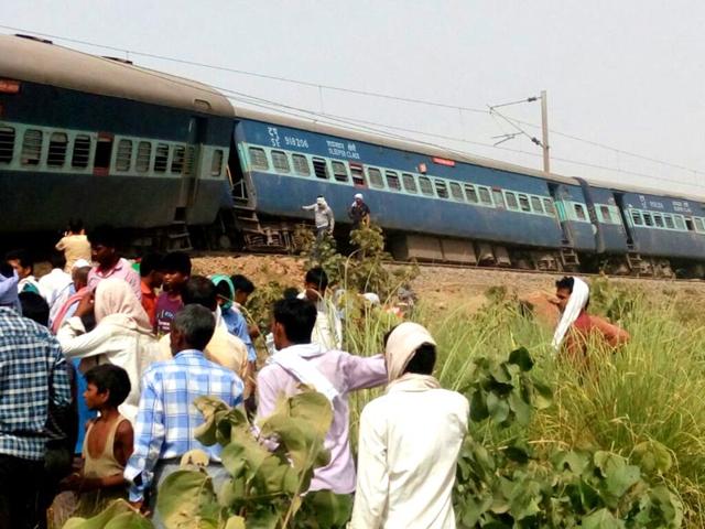 People gather at the accident site. Four people were killed and dozens injured when nine coaches of the Muri Express train derailed near Sirathu in Uttar Pradesh on Monday. (PTI Photo)