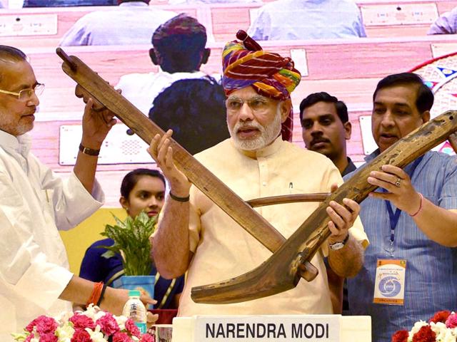 Prime-Minister-Narendra-Modi-being-presented-a-model-of-plough-by-agriculture-minister-Radha-Mohan-Singh-during-the-launch-of-the-DD-Kisan-Channel-at-Vigyan-Bhawan-in-New-Delhi-PTI-Photo