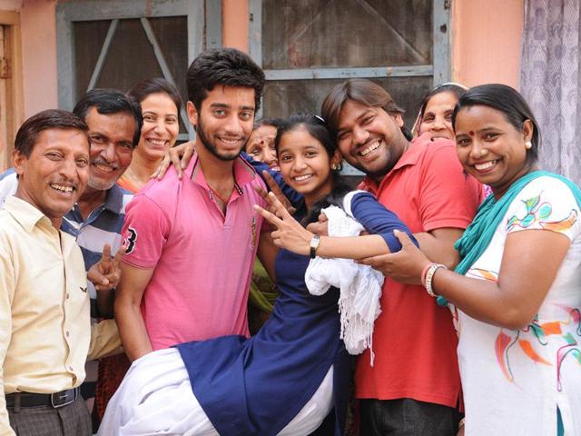 Komal who scored 97.69% marks with her family members in Karatapur near Jalandhar. Pardeep Pandit/HT Photo
