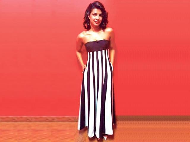 Priyanka Chopra: The actor goes a style mile ahead and pulls off her sexy strapless gown with a pair of matching white and black pumps.