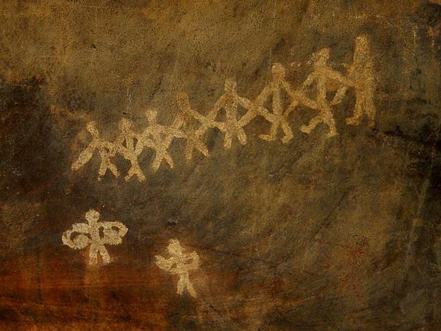 Community living was only possible when the hunter-gatherer settled down to become a farmer. There’s a primitive party going on here – notice the line of dancers and two drummers? 