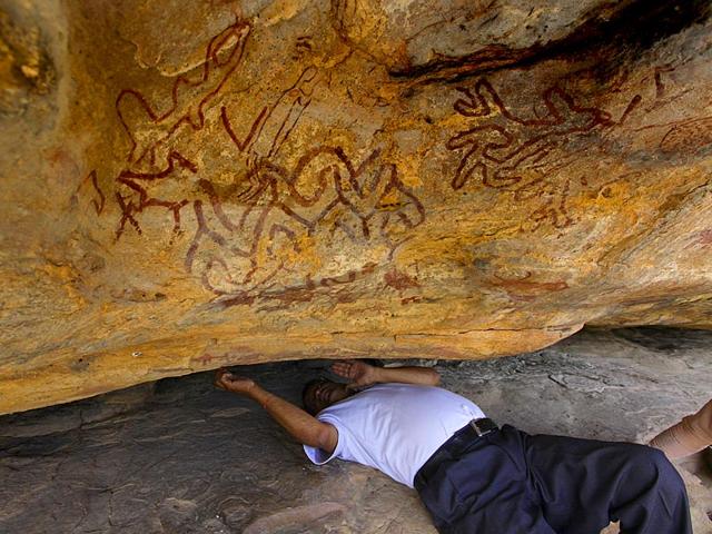 Pradyumn Bhatt, on his back so as to better see some paintings, tells us that the decorations in the foreground might have had special significance for early settlers 