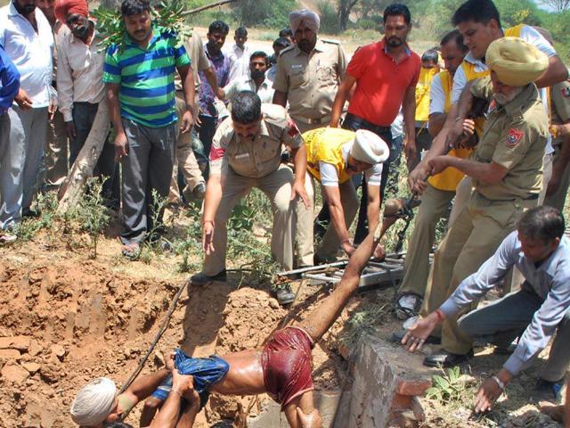 A-rescue-team-pulling-out-the-body-of-a-worker-from-the-sewer-in-Sector-31-Chandigarh-and-right-the-victims-Karun-Sharma-HT-Photo