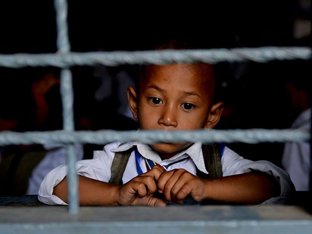 Nepalese schoolboy Jaswoba Chheakna, 4, looks out of the window of a schoolroom in Bhaktapur on the outskirts of Kathmandu. (AFP Photo)
