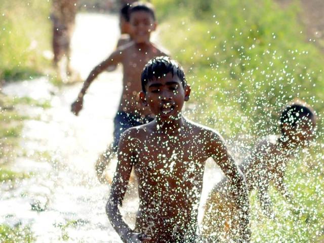 Children playing in water to get respite from scorching heat in village Gazipur on the outskirts of Jalandhar. Pardeep Pandit/HT Photo