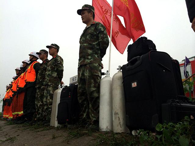 Rescue workers stand near the site where a ship sank, in the Jianli section of the Yangtze River, Hubei province, China. (Reuters photo)