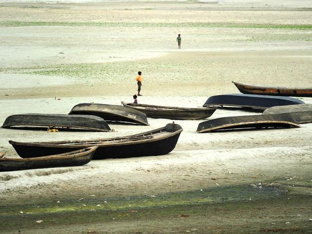 Children of boatmen play in a dry river bed area as the water level of Ganga recedes due to extreme hot weather and short water supply from Tehri dam, in Allahabad. AFP Photo