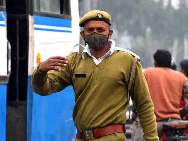A traffic policeman wears a mask as he manages commuter vehicles in Ghaziabad, on the outskirts of New Delhi. AFP Photo
