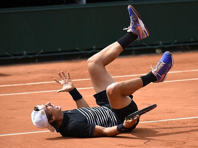 Australia's Thanasi Kokkinakis celebrates after defeating countryman Bernard Tomic during the men's singles second-round match at the 2015 French Open in Paris, France. (AFP Photo)