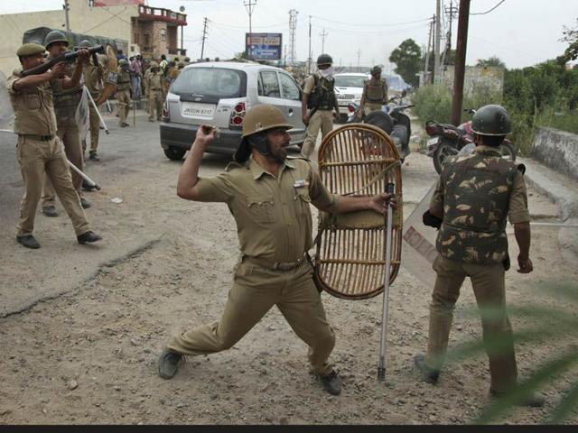 Indian police throwing stones at Sikh protesters as they clash during a protest in Jammu. Photo courtesy: AP