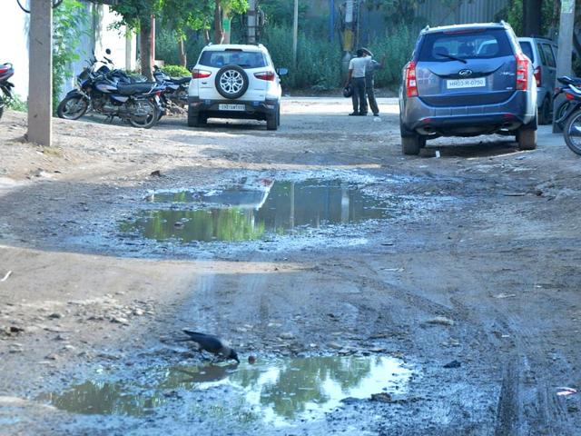 Commuters-having-a-bumpy-ride-on-the-road-filled-with-potholes-Sant-Arora-HT-Photo