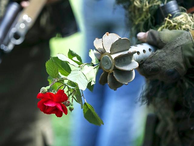 A Ukrainian serviceman holds a mortar round together with a rose at his position in the town of Maryinka, eastern Ukraine. Ukraine's President Petro Poroshenko told his military on Thursday to prepare for a possible 'full-scale invasion' by Russia all along their joint border, a day after the worst fighting with Russian-backed separatists in months. (Reuters)