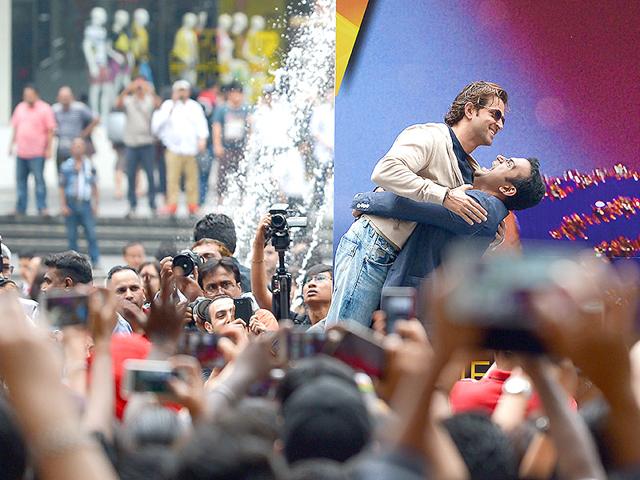 Hrithik Roshan is hugged as he arrives at a shopping mall during a fan meet event on the first day of the 16th IIFA Awards in Kuala Lumpur. (AFP Photo)