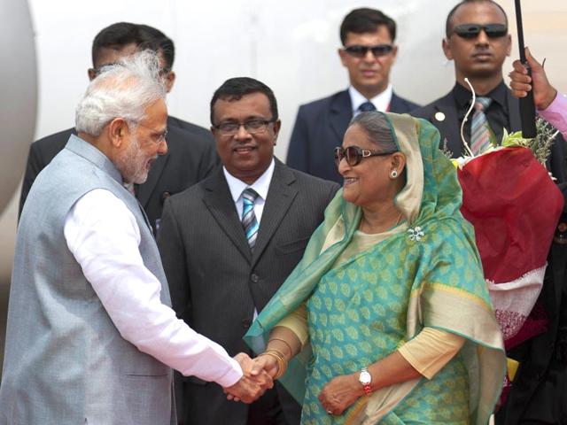 Bangladesh’s Prime Minister Sheikh Hasina shakes hand with Narendra Modi upon his arrival at the Hazrat Shahjalal International airport in Dhaka, Bangladesh. (AP Photo)