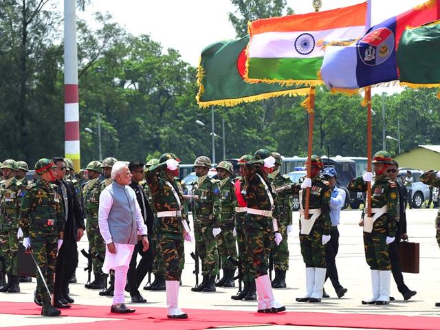 Prime Minister Narendra Modi inspects the Bangladeshi guard of honour on his arrival at the Hazrat Shahjalal International Airport in Dhaka . AFP PHOTO