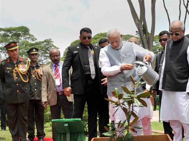 Prime Minister Narendra Modi plants a sapling at National Martyrs' Memorial during a visit, in Dhaka . PTI Photo