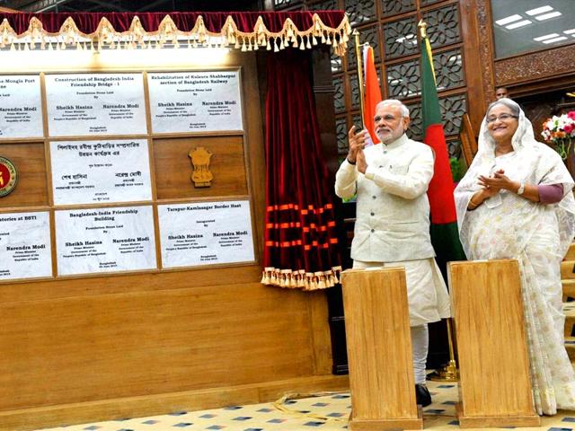 Prime Minister Narendra Modi and Bangladesh PM Sheikh Hasina during the joint unveiling of foundation stones of various project in Dhaka . PTI Photo