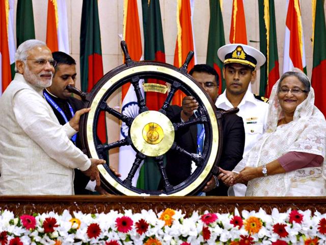 Prime Minister Narendra Modi presents a ship's wheel to Bangladesh's Prime Minister Sheikh Hasina in Dhaka. REUTERS