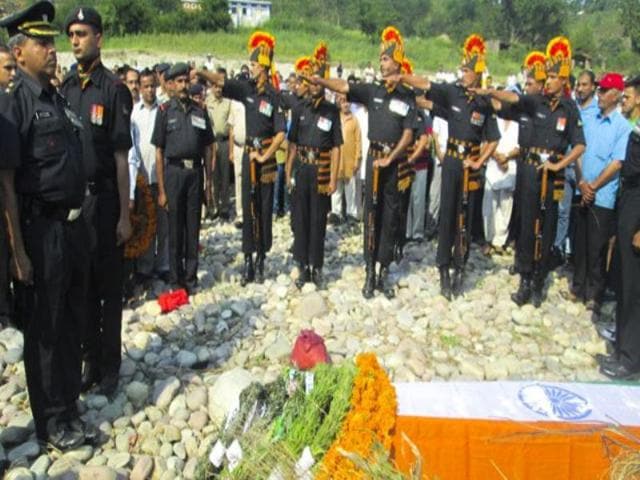 Soldier paying tribute to martyred comrade Lance Naik Rajneesh Singh in Garli village of Kangra district. HT Photo