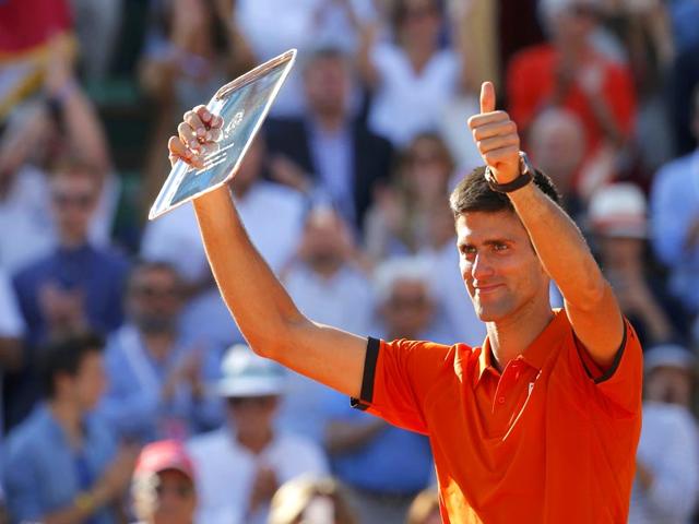 Novak Djokovic of Serbia poses with the runners-up trophy during the presentation ceremony after being defeated by Stan Wawrinka of Switzerland in the men's singles final of the French Open in Paris, France. (Reuters Photo)