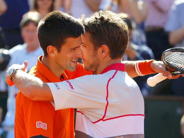 Stan Wawrinka of Switzerland (R) hugs Novak Djokovic of Serbia after winning the men's singles final match at the French Open in Paris, France. (Reuters Photo)