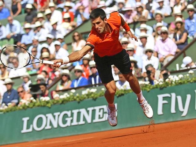 Serbia's Novak Djokovic lunges for the ball in the second set of the men's singles final of the French Open against Switzerland's Stan Wawrinka, in Paris, France. (AP Photo)