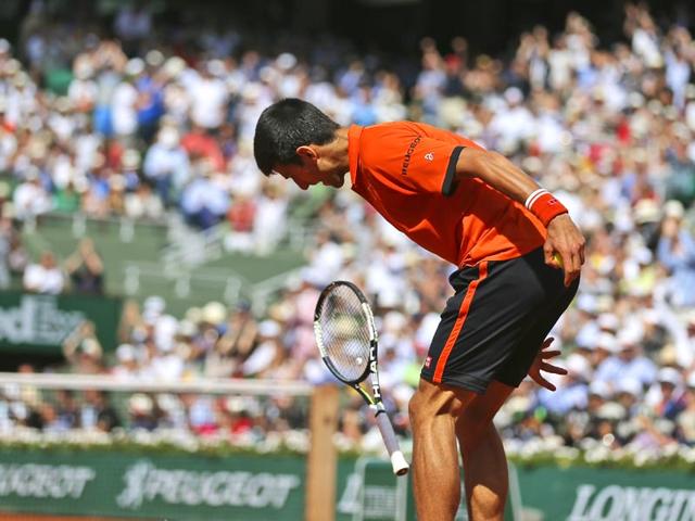 Serbia's Novak Djokovic tries to break his racquet after losing the second set in the men's singles final of the French Open against Switzerland's Stan Wawrinka, in Paris, France. (AP Photo)