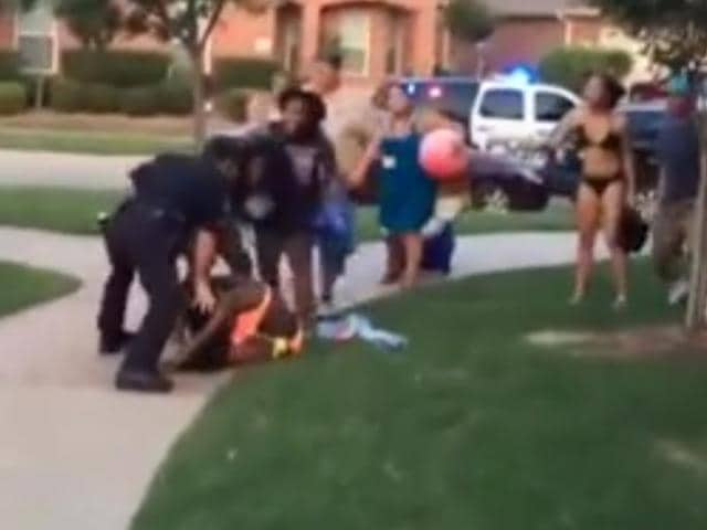 One-officer-can-be-seen-throwing-a-girl-to-the-ground-and-pinning-her-down-credits-Youtube-grab One-officer-can-be-seen-throwing-a-girl-to-the-ground-and-pinning-her-down-credits-Youtube-grab