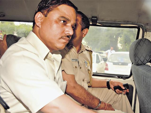 Delhi-law-minister-Jitender-Singh-Tomar-who-is-the-Tri-Nagar-MLA-in-a-police-car-on-his-way-from-AIIMS-to-the-Saket-court-that-ordered-him-in-police-custody-for-four-days-on-Tuesday-HT-Photo