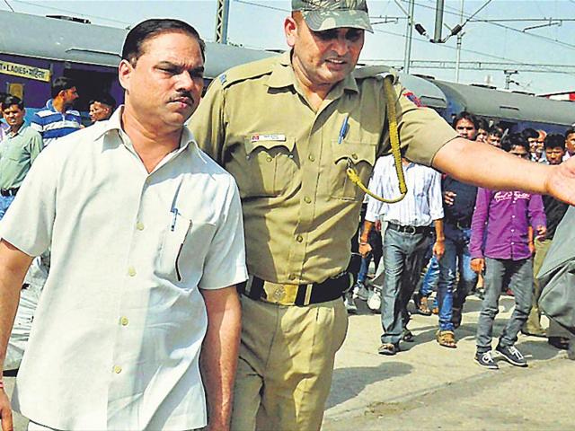 Jitender-Tomar-who-quit-as-Delhi-law-minister-after-his-arrest-on-charges-of-faking-his-college-degrees-at-Charbargh-railway-station-in-Lucknow-on-his-way-to-Faizabad-on-Wednesday-PTI-Photo Jitender-Tomar-who-quit-as-Delhi-law-minister-after-his-arrest-on-charges-of-faking-his-college-degrees-at-Charbargh-railway-station-in-Lucknow-on-his-way-to-Faizabad-on-Wednesday-PTI-Photo