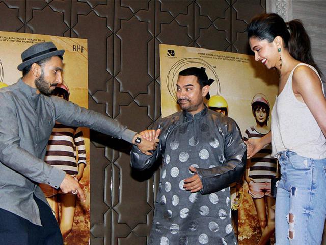 Is Aamir Khan about to officiate at the wedding of Ranveer Singh and Deepika Padukone? Naah, the young actors are just trying to get him to the dance floor...(Photo: PTI)