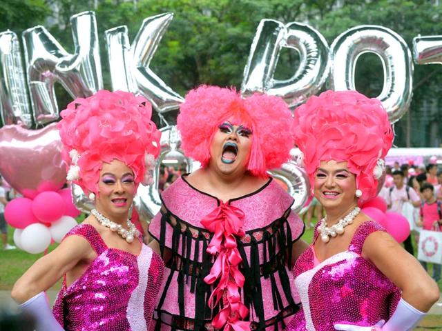 Participants dressed in pink pose for a photograph at the annual "Pink Dot" event in a public show of support for the LGBT community at Hong Lim Park in Singapore(AFP Photo)