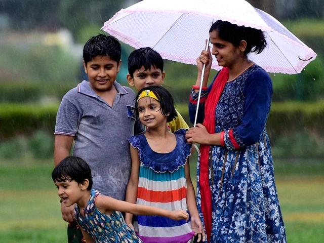 Children enjoy the monsoon shower in New Delhi (PTI Photo)