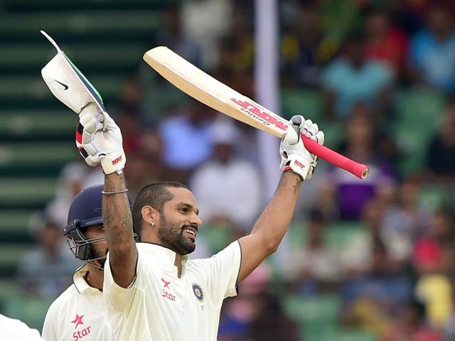 Indian cricketer Shikhar Dhawan celebrates after scoring a century during the Test match between Bangladesh and India at Fatullah on June 14, 2015. (AFP Photo)