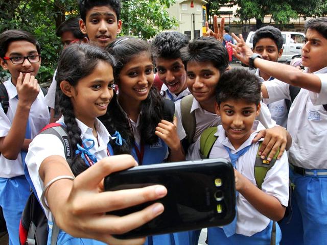 Students take selfies on the first day of school in Thane. (Photo: Praful Gangurde)