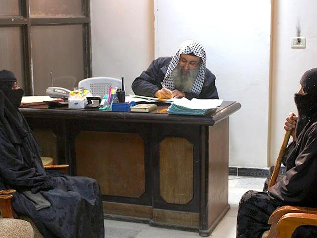 In-this-photo-released-by-a-militant-website-which-has-been-verified-and-is-consistent-with-other-AP-reporting-two-women-sit-in-the-office-of-an-Islamic-State-group-judge-at-an-Islamic-court-in-al-Tabqa-town-in-Raqqa-City-Syria-Militant-website-via-AP In-this-photo-released-by-a-militant-website-which-has-been-verified-and-is-consistent-with-other-AP-reporting-two-women-sit-in-the-office-of-an-Islamic-State-group-judge-at-an-Islamic-court-in-al-Tabqa-town-in-Raqqa-City-Syria-Militant-website-via-AP