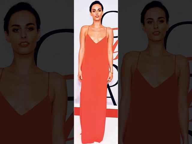 Colour you pretty: Actor Sophie Auster pairs her bright-hued slip dress with an equally vibrant lipstick and bronzed eye makeup. Go sans accessories like the diva. (AFP Photo)