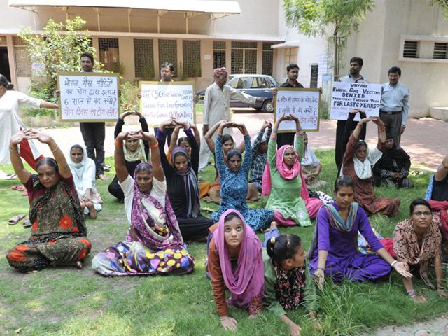 Survivors of Bhopal gas tragedy hold a demo outside a non-functional Yoga Centre to protest the denial of yoga therapy benefits to them, in Bhopal on Saturday. (HT)