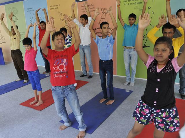 Differently-abled children of NGO Arushi perform yoga on the eve of International Day of Yoga, in Bhopal on Saturday. (Praveen Bajpai/HT)