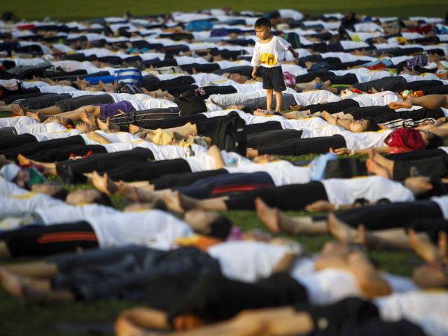 A boy is seen playing during the International Day of Yoga festival in Kuala Lumpur, Malaysia. (AP Photo)