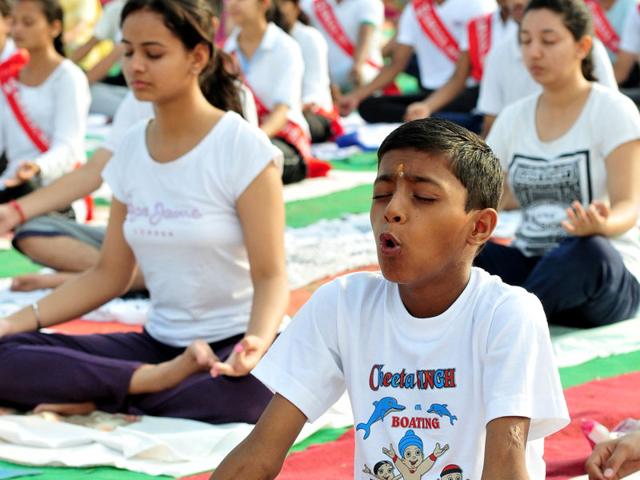 Students participating in International yoga day celebration at Exhibition Ground Sector 34 in Chandigarh on Sunday. (Keshav Singh/HT Photo)