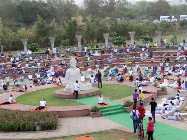 People perform Yoga at Sukhna Lake in Chandigarh. (Gurpreet Singh/HT Photo)