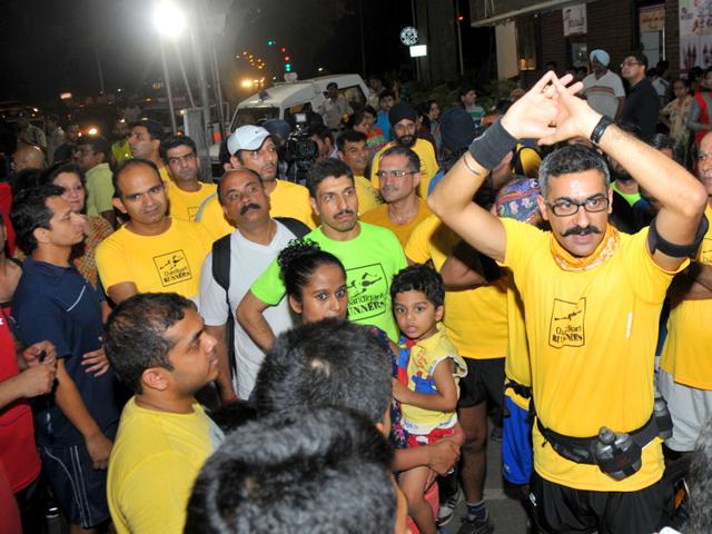 Participants during the night run that started from Aroma light point to Sukhna Lake in Chandigarh on Saturday. (Ravi Kumar/HT Photo)