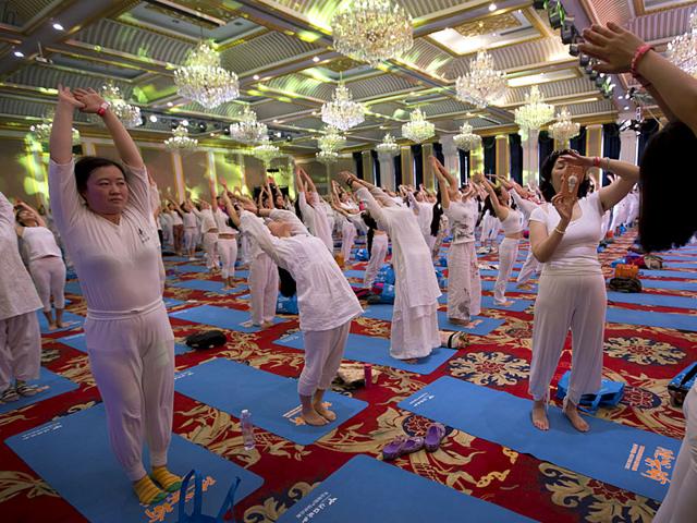 Yoga enthusiasts at a hotel banquet hall in Changping District, on the outskirts of Beijing, China. (AP Photo)
