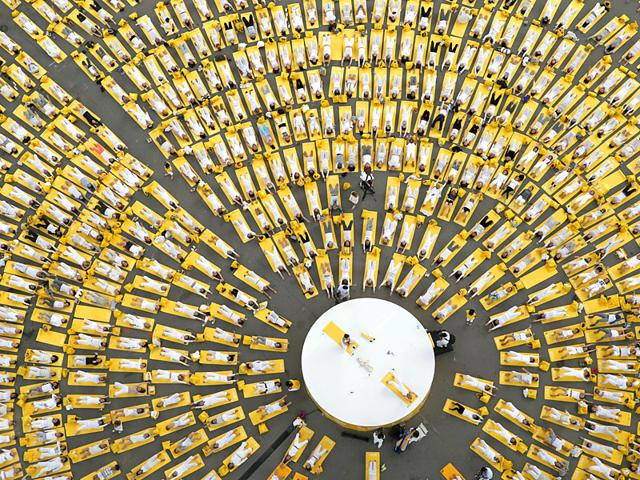 People perform yoga under the Eiffel Tower in Paris. (Reuters Photo)